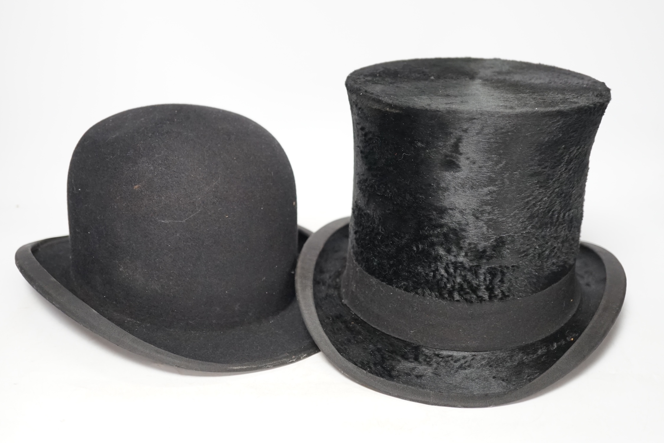 An early 20th century Alfred Townsend, Jermyn St, St James’s black bowler hat and a similar aged black silk top hat, both small sizes. Condition - fair